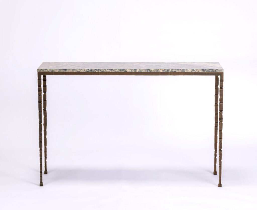 Rectangular table with a gray marble top and ornate segmented wooden legs, set against a plain white background.