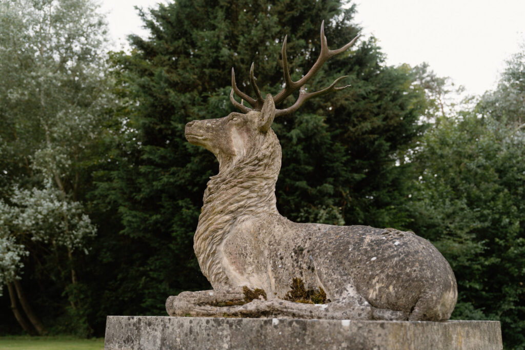Reclining Stag garden Statue in stone In Situ 2